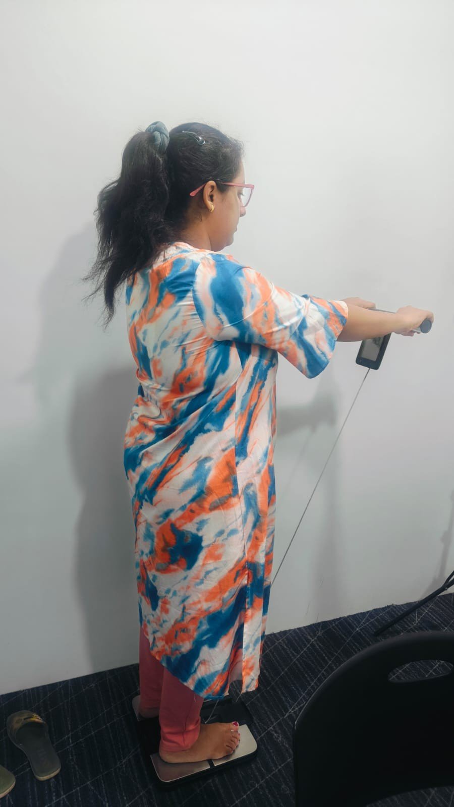 Client on weighing machine for body composition analysis at NutriEat Clinic Pune